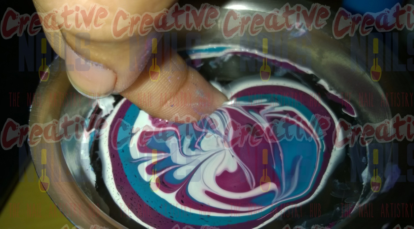 Dip your finger to get the design on your nails